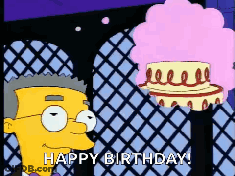 A Cartoon Character From The Simpsons Is Standing Next To A Cake With A Pink Wig . GIF