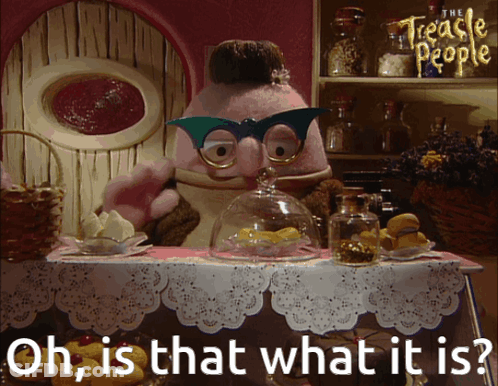 A Cartoon Character From The Treacle People Is Standing At A Table GIF
