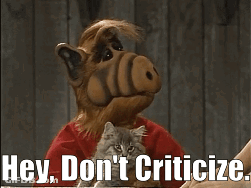 A Cartoon Character Holding A Kitten With The Words Hey Don 'T Criticize GIF