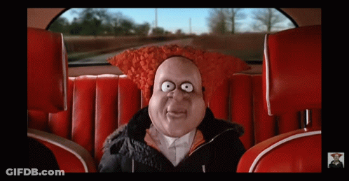 A Cartoon Character In A Car With A Red Hat On GIF