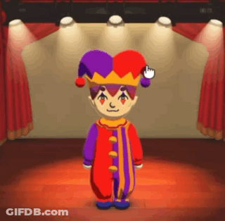 A Cartoon Character In A Jester Costume Is Standing On A Stage In Front Of A Red Curtain . GIF