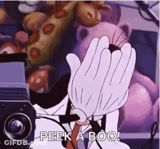 A Cartoon Character Is Covering His Face With His Hands In Front Of A Projector . GIF