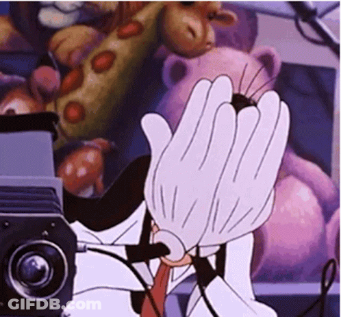 A Cartoon Character Is Covering His Face With His Hands In Front Of A Toy Camera . GIF