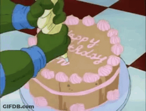 A Cartoon Character Is Frosting A Cake That Says Happy Birthday On It GIF