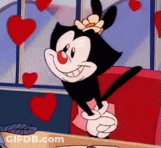 A Cartoon Character Is Giving A Peace Sign While Sitting In A Diner Surrounded By Hearts . GIF