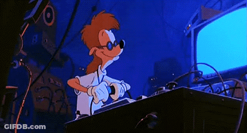 A Cartoon Character Is Giving A Thumbs Up While Sitting At A Desk GIF