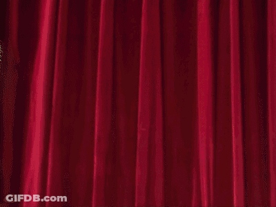 A Cartoon Character Is Holding A Chainsaw In Front Of A Red Curtain .. GIF