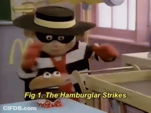 A Cartoon Character Is Holding A Hamburger With The Words Fig 1 The Hamburger Strikes Below Him GIF