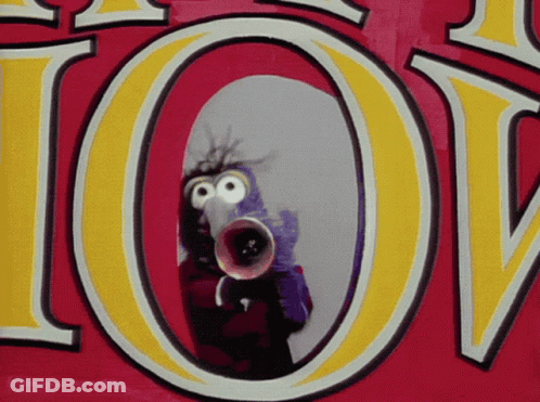 A Cartoon Character Is Holding A Megaphone In Front Of A Sign That Says Love GIF