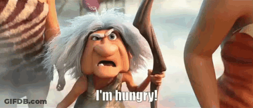 A Cartoon Character Is Holding A Stick And Saying I 'M Hungry ! GIF
