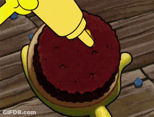 A Cartoon Character Is Icing A Cake With A Yellow Piping Bag GIF