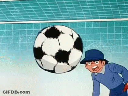 A Cartoon Character Is Kicking A Soccer Ball In A Goal . GIF