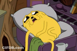 A Cartoon Character Is Laying In A Bed With A Pillow GIF