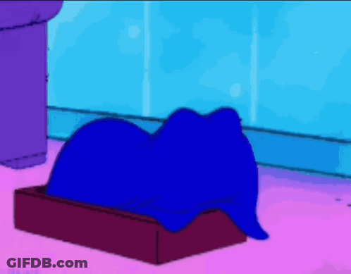 A Cartoon Character Is Laying In A Box With The Letter G On The Top GIF