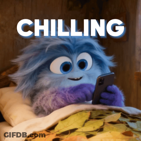 A Cartoon Character Is Laying In Bed Looking At A Cell Phone With The Words Chilling Above Him GIF