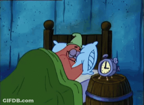 A Cartoon Character Is Laying In Bed Next To An Alarm Clock That Reads 3:00 GIF