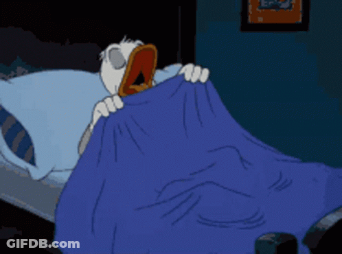 A Cartoon Character Is Laying In Bed With A Blue Blanket GIF