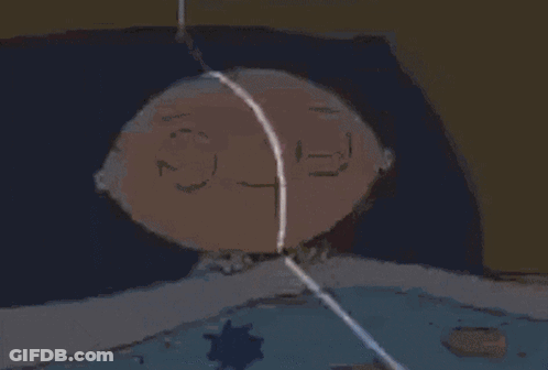 A Cartoon Character Is Laying In Bed With A Blue Blanket . GIF