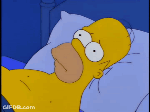 A Cartoon Character Is Laying In Bed With An Alarm Clock That Says 1:00 GIF