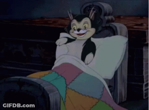 A Cartoon Character Is Laying On A Couch With A Blanket On . GIF