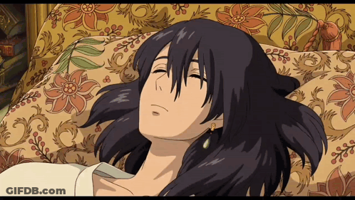 A Cartoon Character Is Laying On A Couch With A Floral Blanket GIF