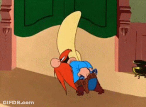 A Cartoon Character Is Laying On The Floor With A Gun In His Hand GIF