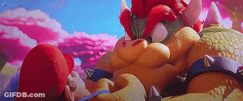 A Cartoon Character Is Laying On The Ground Next To A Giant Cartoon Character . GIF