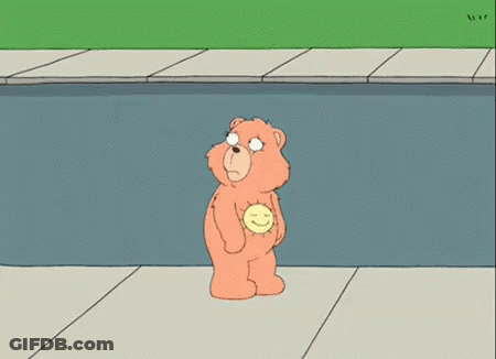 A Cartoon Character Is Laying On The Ground On The Sidewalk . GIF