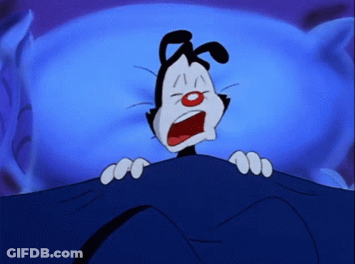 A Cartoon Character Is Laying Under A Blue Blanket GIF