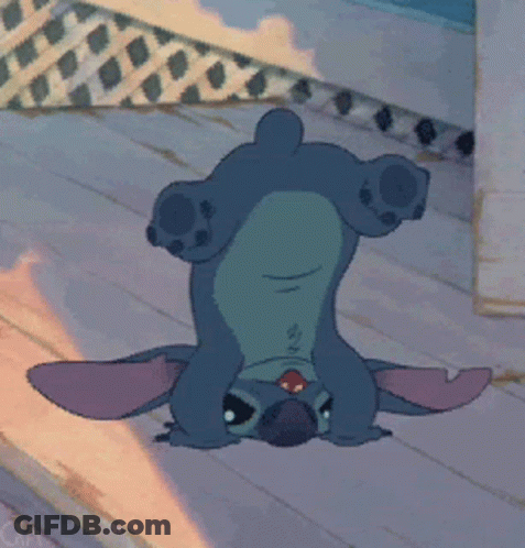 A Cartoon Character Is Laying Upside Down On A Wooden Floor GIF