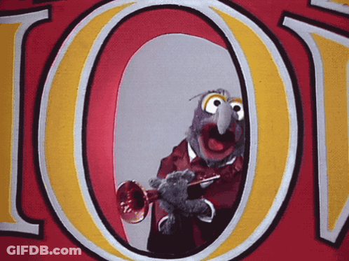 A Cartoon Character Is Playing A Trumpet In Front Of A Large Letter O GIF
