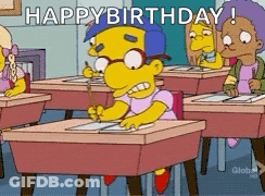 A Cartoon Character Is Sitting At A Desk In A Classroom And Says " Happy Birthday " GIF