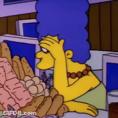 A Cartoon Character Is Sitting At A Table With A Bunch Of Food On It . GIF