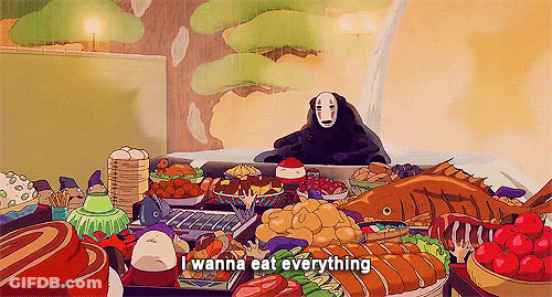 A Cartoon Character Is Sitting At A Table With A Lot Of Food . GIF