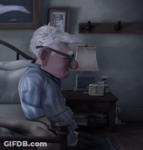 A Cartoon Character Is Sitting In A Chair With A Lamp And A Clock On The Table GIF