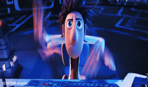 A Cartoon Character Is Sitting In Front Of A Computer GIF