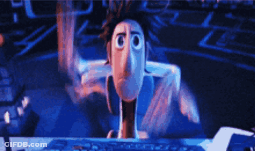 A Cartoon Character Is Sitting In Front Of A Computer GIF