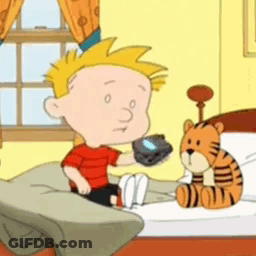 A Cartoon Character Is Sitting On A Bed Holding A Remote Control GIF