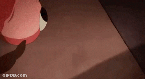 A Cartoon Character Is Sitting On A Bed With A Shadow Of A Person On The Floor . GIF