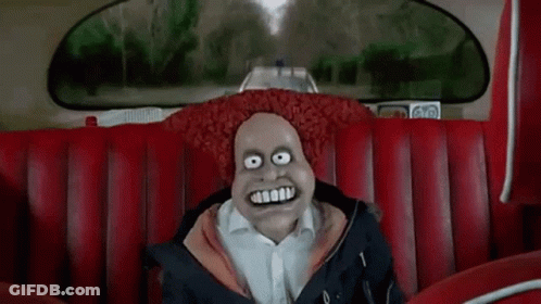 A Cartoon Character Is Sitting On A Red Couch In A Car With A Big Smile On His Face . GIF
