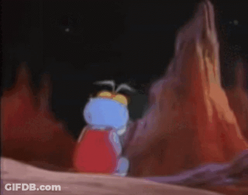 A Cartoon Character Is Sitting On A Rock And Looking Sad GIF