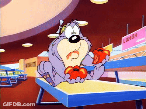 A Cartoon Character Is Sitting On A Table Eating Tomatoes In A Cafeteria . GIF