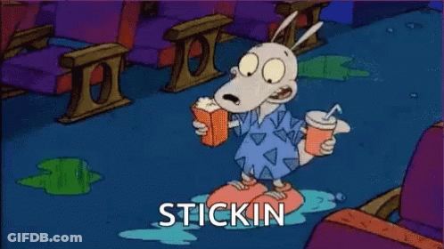 A Cartoon Character Is Sitting On The Floor With A Drink And A Book . GIF