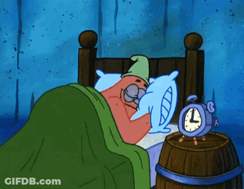 A Cartoon Character Is Sleeping In A Bed Next To An Alarm Clock That Says L On It GIF