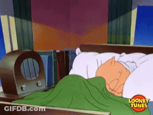 A Cartoon Character Is Sleeping In A Bed With A Looney Tunes Logo On The Bottom GIF