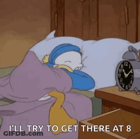 A Cartoon Character Is Sleeping In A Bed With An Alarm Clock Next To Him . GIF