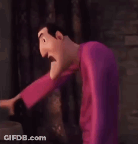 A Cartoon Character Is Standing In Front Of A Brick Wall And Making A Funny Face . GIF
