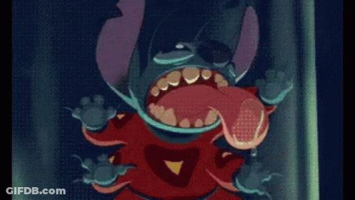 A Cartoon Character Is Standing In Front Of A Dark Curtain GIF