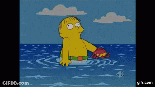 A Cartoon Character Is Standing In The Ocean Holding A Crab In His Hand . GIF