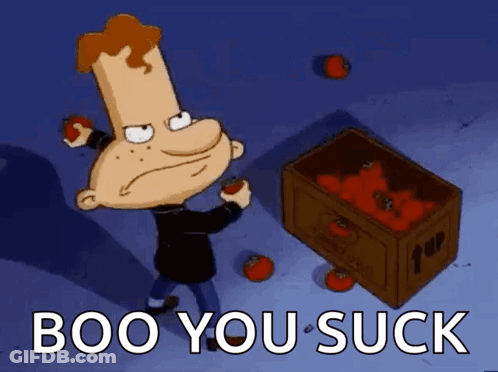 A Cartoon Character Is Standing Next To A Box Of Tomatoes With The Words Boo You Suck Below Him GIF